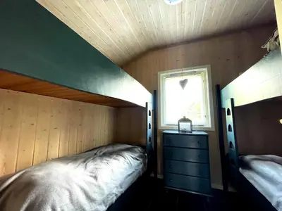 a small bedroom with a bed and a window at Revehiet - 3 bedroom cabin in the center of Geilo in Geilo