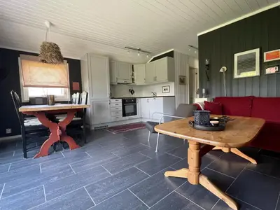 a living room with a table and a couch at Revehiet - 3 bedroom cabin in the center of Geilo in Geilo