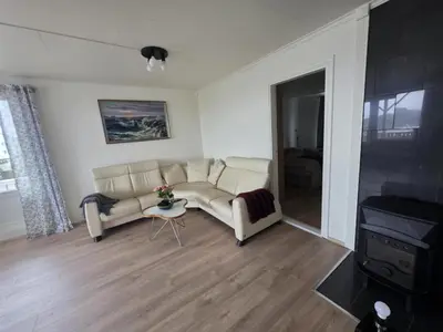 a living room with a couch and a tv at Best flat in town in Kristiansund