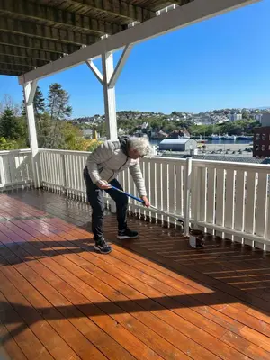 a man holding a pole on a deck at Best flat in town in Kristiansund