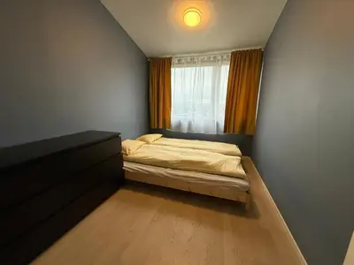 a small bedroom with a bed and a window at Home with 5 bedrooms, great view and garden in Bergen
