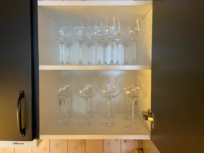 a bunch of wine glasses in a cabinet at Fantastisk utsikt i Hemsedal med ski in og ski ut in Fausko