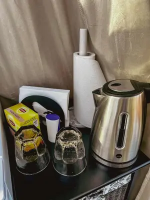 a counter top with a coffee maker and a tea kettle at A little corner of paradise in Molde