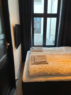 a bed in a room with a window at Ålesund Central Apartment in Ålesund