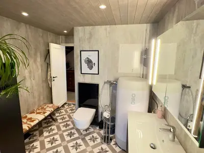 a bathroom with a sink and a toilet in a room at 6 person holiday home in Huglo in Nordhuglo