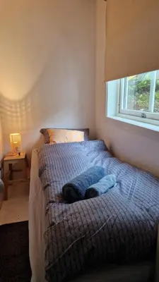 a bedroom with a bed with two towels on it at Seaside cabin with stunning view! in Ålesund