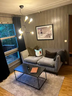 a living room with a couch and a table at Hafjell Alpinlandsby in Hafjell