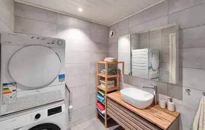 a bathroom with a sink and a washing machine at 3 Bedroom Awesome Home In Rossland in Rossland