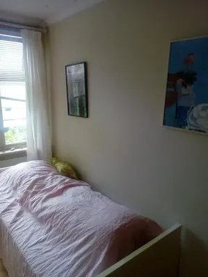 a bedroom with a bed and a picture on the wall at Room2B in Bergen