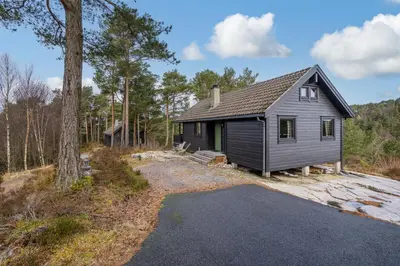 a small house in the middle of a forest at Mortenhytta, Valevåg in Valevåg