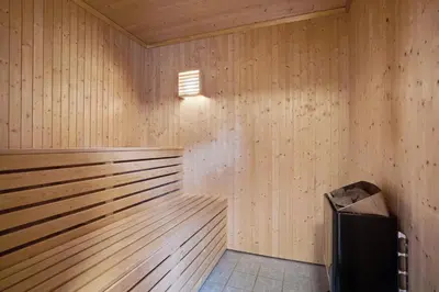 a wooden sauna with a trash can in it at Mortenhytta, Valevåg in Valevåg