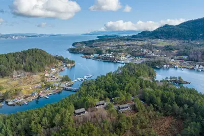 an aerial view of a river with a town at Mortenhytta, Valevåg in Valevåg
