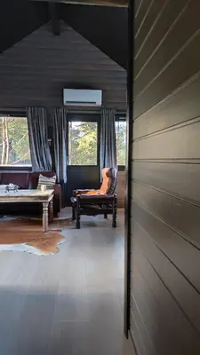 a living room with a couch and a chair at Mortenhytta, Valevåg in Valevåg