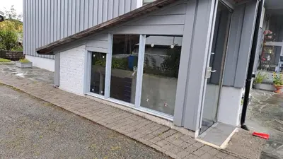 a sliding glass door of a building at Garsoniera in Leirvåg
