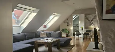 a living room with a couch and a table at Leilighet Bergen Sandviken in Bergen