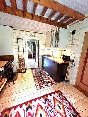 a kitchen with a counter and a table in a room at WOOD HOUSE GARDEN Lakeview Mjøsa -30 min OSL