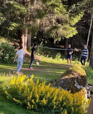 a group of people playing frisbee in a park at WOOD HOUSE GARDEN Lakeview Mjøsa -30 min OSL