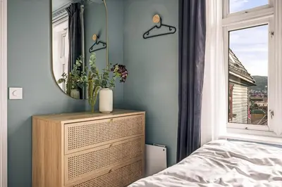 a bedroom with a dresser and a mirror at Bispengsgaten 16 in Bergen