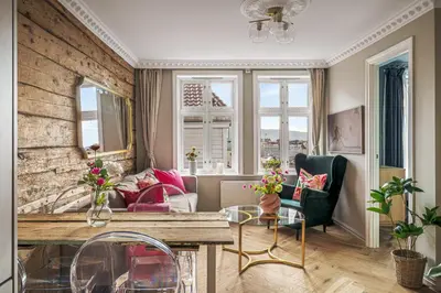 a living room with a table and a couch at Bispengsgaten 16 in Bergen