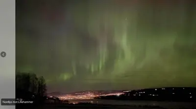 an aurora in the sky over a city at Villa Solås in Lillehammer