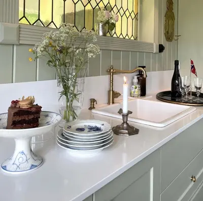 a table with a cake and a candle on a counter at Villa Solås in Lillehammer