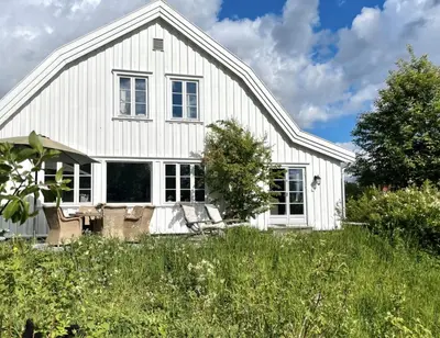 a white house with a field of grass at Villa Solås in Lillehammer