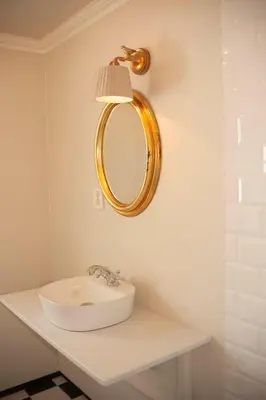 a bathroom with a sink and a mirror on the wall at Villa Solås in Lillehammer