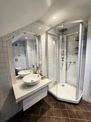 a bathroom with two sinks and a shower at Sentrumsidyll ved fjord og fjell in Molde