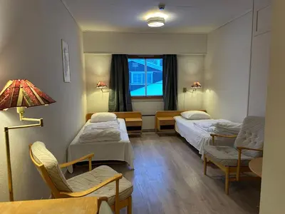 a hospital room with two beds and a lamp at Bjorliheimen Fjellhotell-Hotellrom in Bjorli