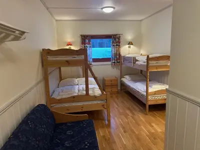 a room with two bunk beds and a window at Bjorliheimen Fjellhotell-Hotellrom in Bjorli