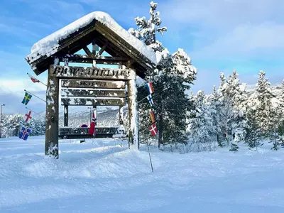 a snow covered gazebo with a person sitting in it at Bjorliheimen Fjellhotell-Hotellrom in Bjorli