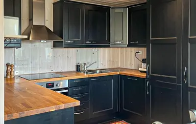 a kitchen with black cabinets and a sink at Gorgeous Home In Rauland With Sauna in Rauland
