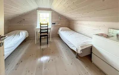 a room with two beds and a desk and a chair at Gorgeous Home In Rauland With Sauna in Rauland