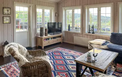 a living room with a couch and a tv at Gorgeous Home In Rauland With Sauna in Rauland