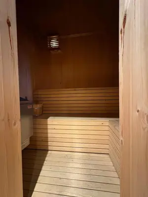 a room with a sauna with a wooden floor at Lomtjern in Beitostøl
