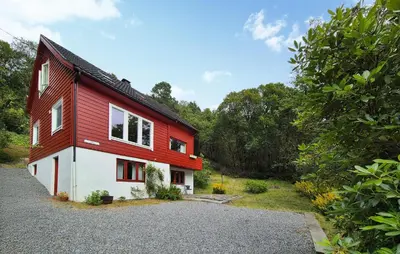 a red and white house with trees in the background at Lovely Home In Masfjordnes With Wifi in Masfjorden