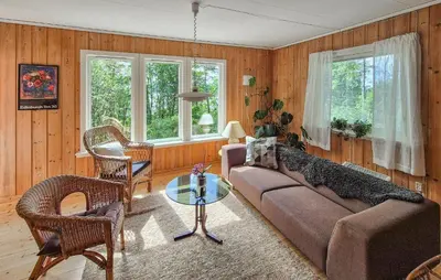 a living room with a couch and chairs and windows at Lovely Home In Masfjordnes With Wifi in Masfjorden