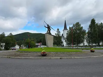 a statue in the middle of a street with a church at 6 person holiday home in Osen