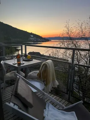 a balcony with a table and a view of the water at Exclusive flat with amazing view over the fjord in Trondheim