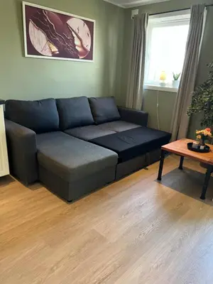 a living room with a couch and a table at Mai Tran in Gjøvik