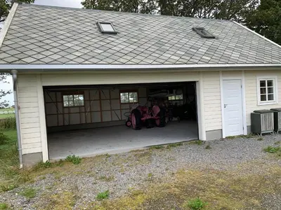 a large garage with two motorcycles in it at Flø Feriehus med Badstue in Ulstein