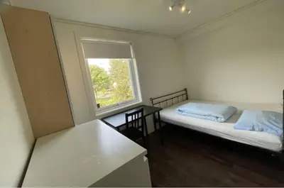 a small room with a bed and a window at Alfred Apartment in Trondheim in Trondheim