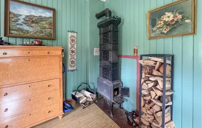 a room with a wood stove in the corner at Stunning Home In Engerdal With Wifi in Nymoen