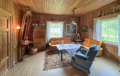 a living room with a couch and a table at Stunning Home In Engerdal With Wifi in Nymoen