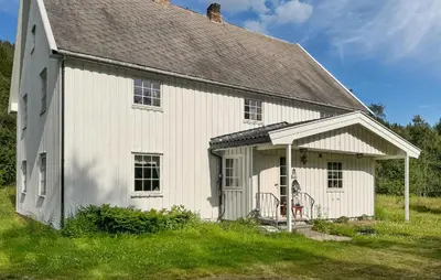 a white house with a gambrel roof at Stunning Home In Engerdal With Wifi in Nymoen