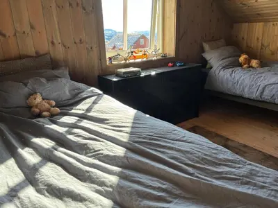 two teddy bears sitting on a bed in a bedroom at Ski inn ski out, downhill and crosscountry Holtardalen in Torvetjørn