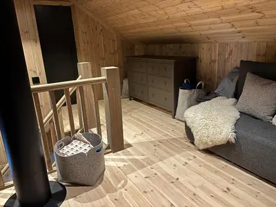 a living room with a couch and a wooden floor at Ski inn ski out, downhill and crosscountry Holtardalen in Torvetjørn