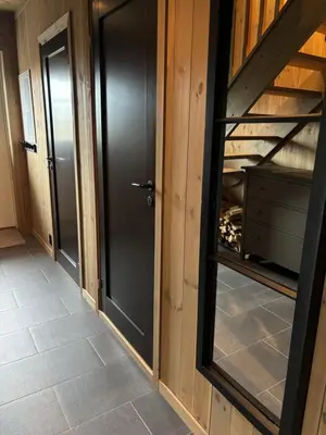 a hallway with a door and a glass cabinet at Ski inn ski out, downhill and crosscountry Holtardalen in Torvetjørn