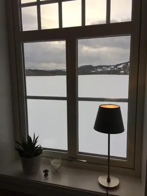 a window with a view of a body of water at Gårdsleilighet in Verdal