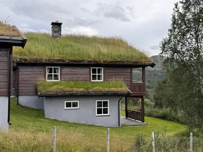 a house with a grassy roof with windows at Høvringen Lodge in Høvringen